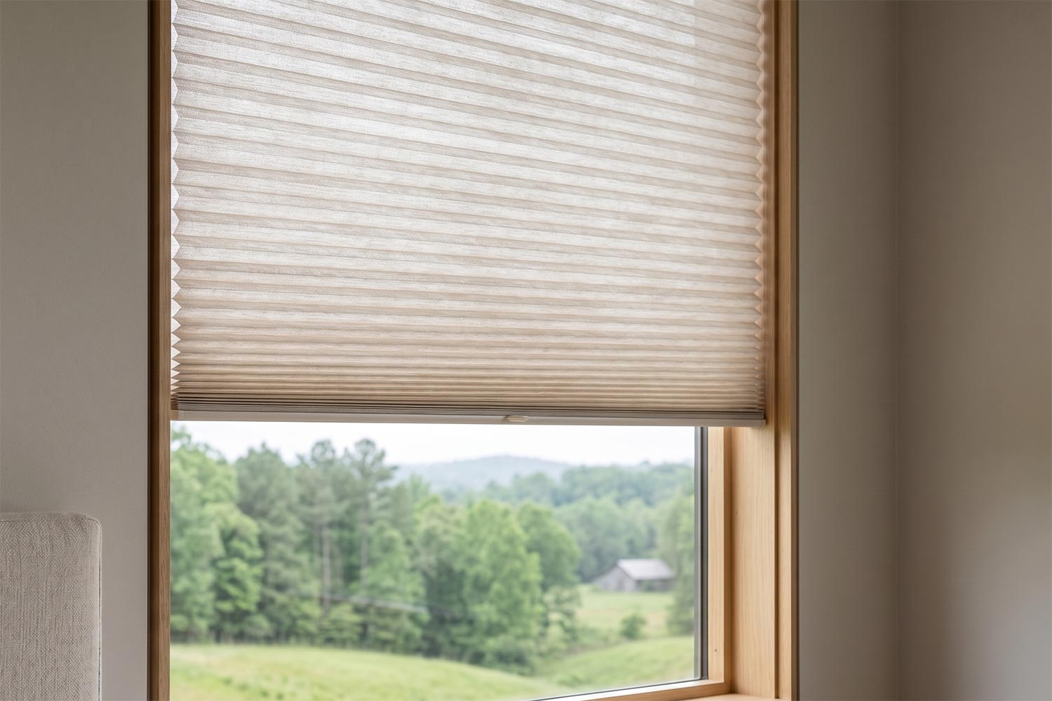 Cellular shades partially raised on a bedroom