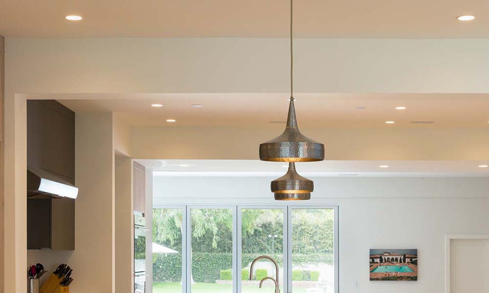 Stainless steel recessed downlights in a wood ceiling panel over a yacht shower