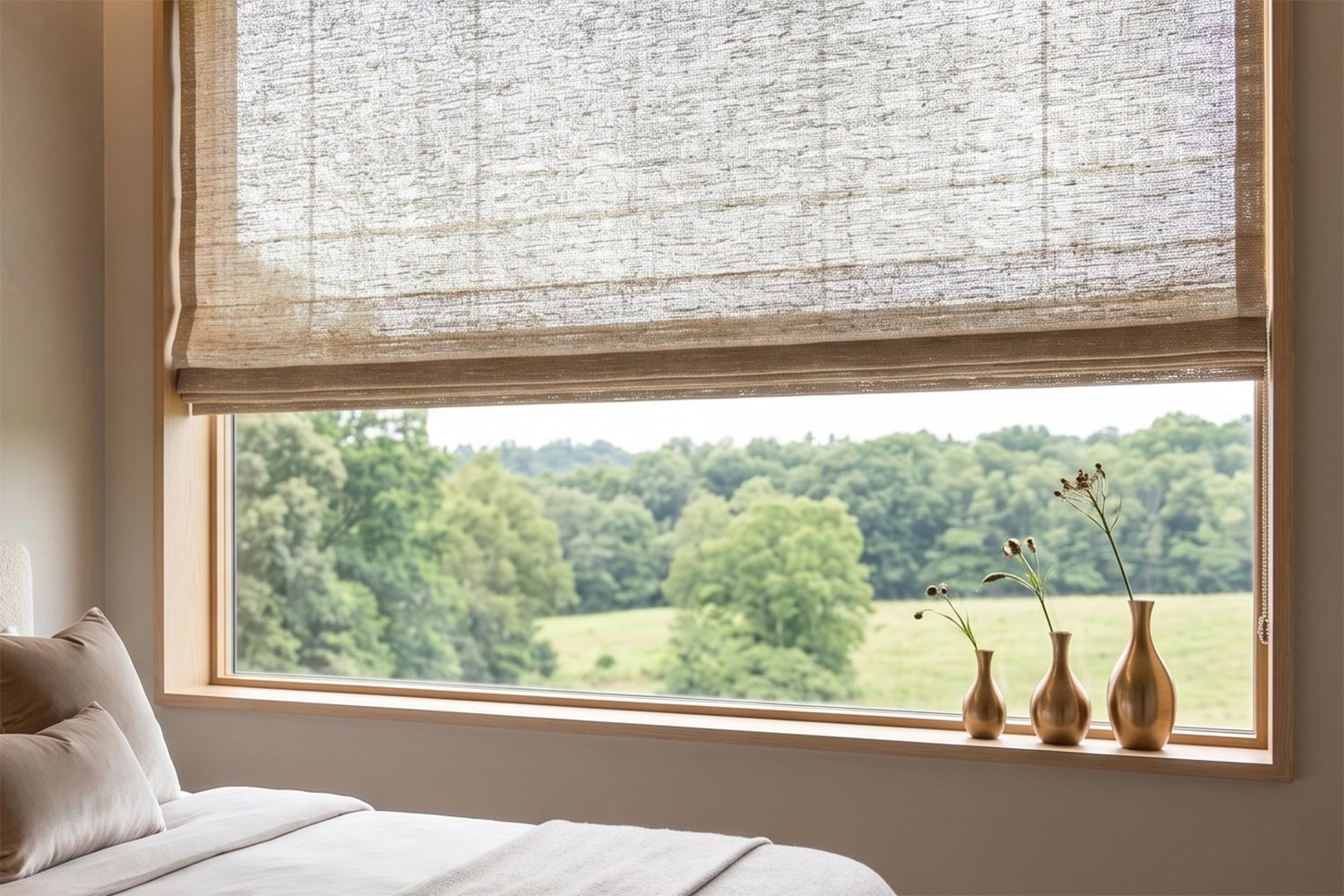Wove Roman shades covering a window in a bedroom